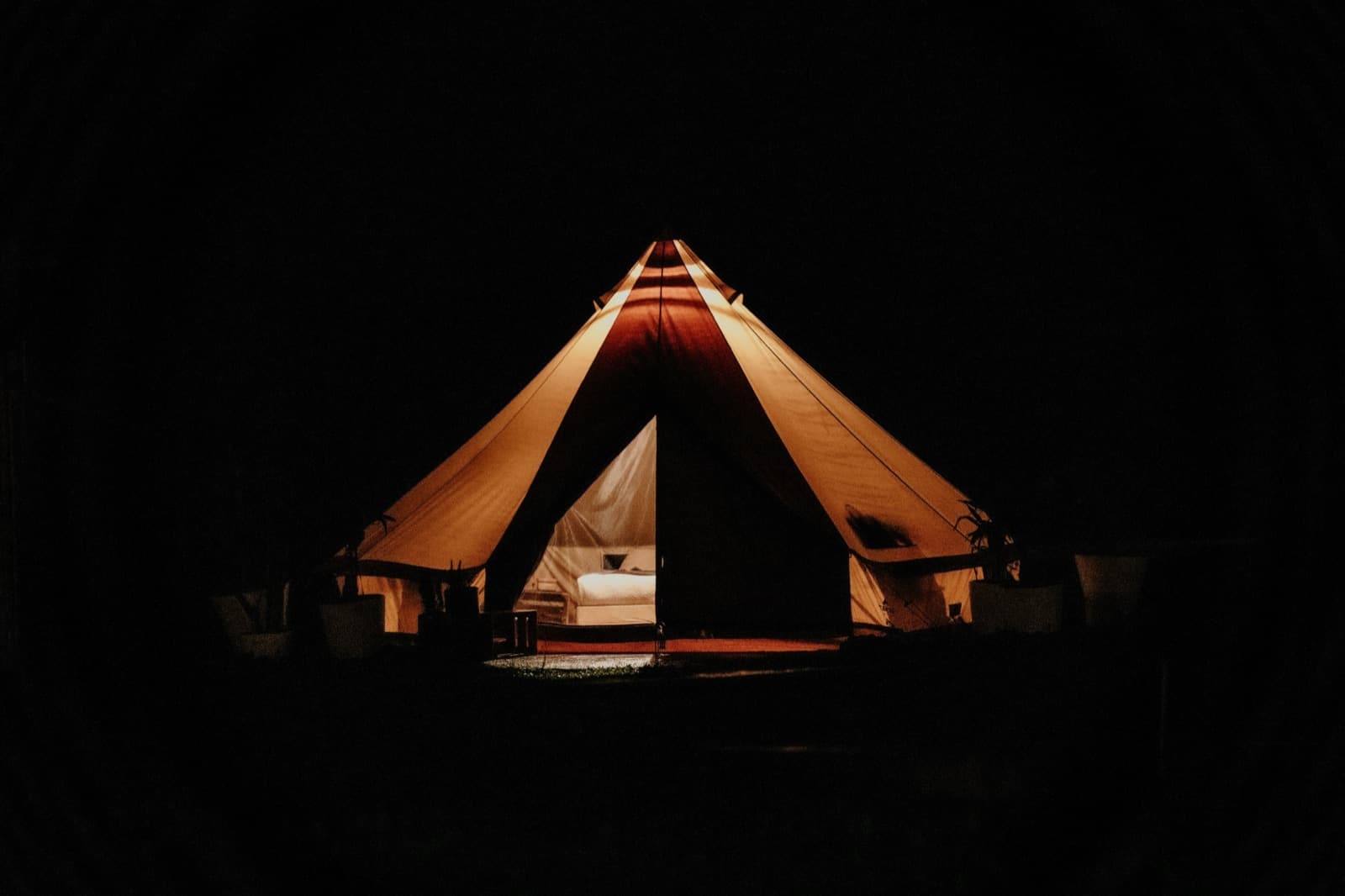 Rows of glamping bell tents at dusk