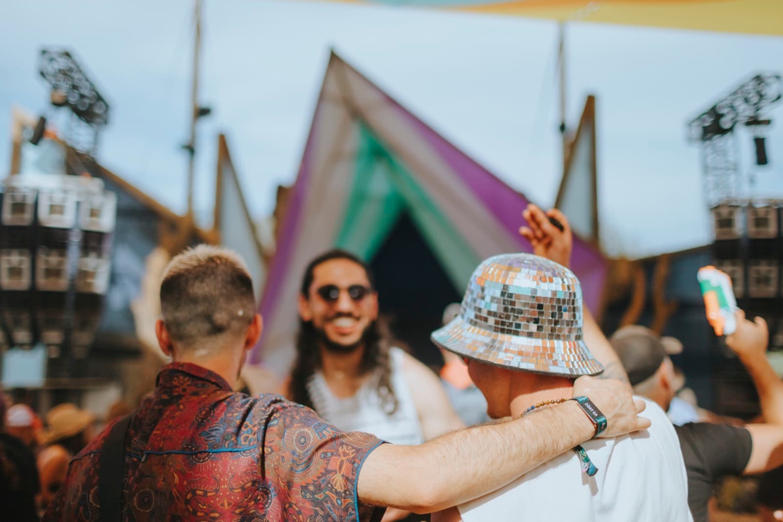 Festival crowd with hands raised at golden hour